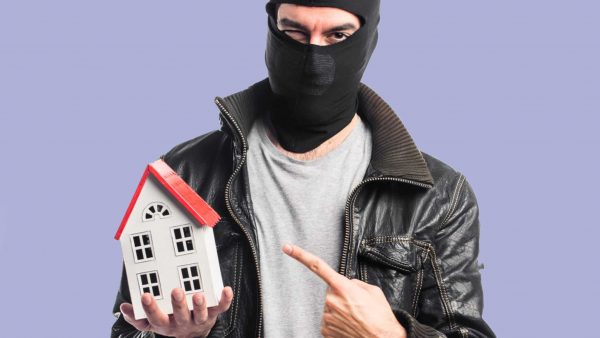 Robber holding a little house